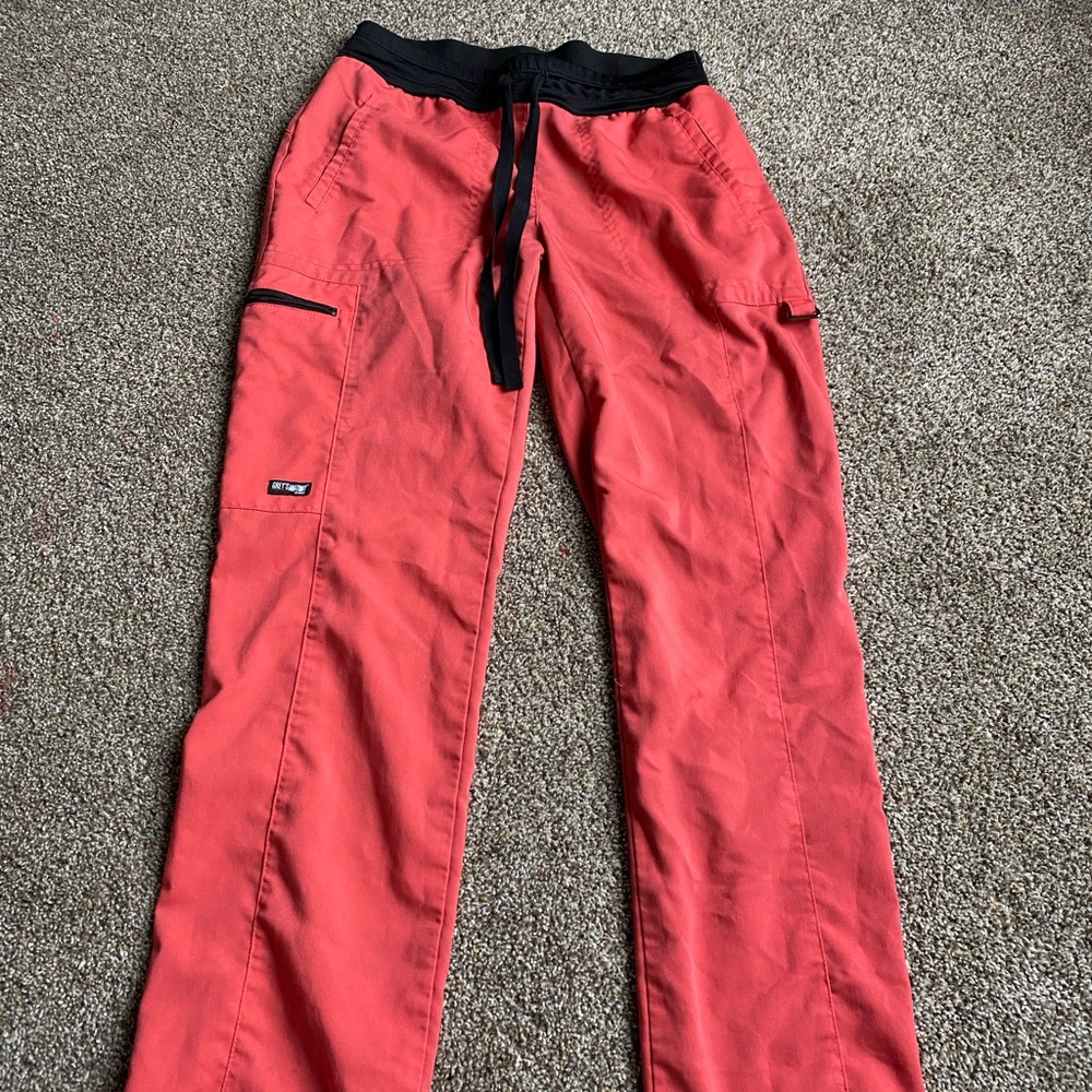 Cute coral scrub bottoms with tears on strap back side